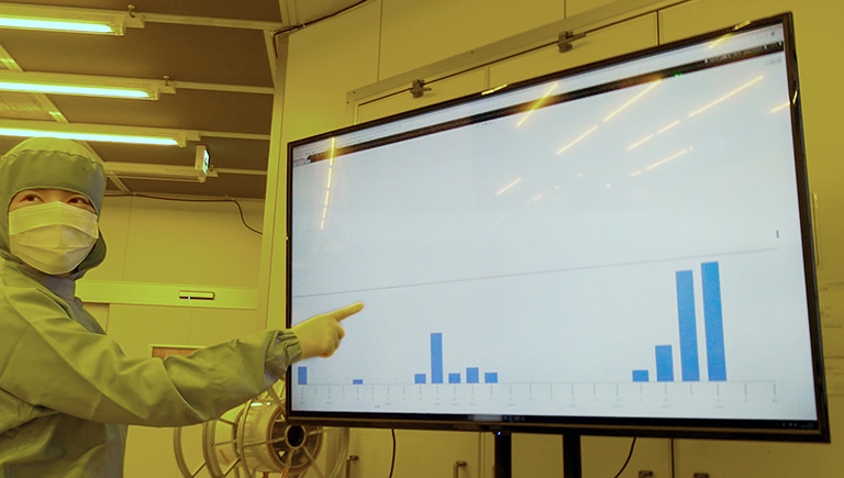Staff member pointing at a monitor